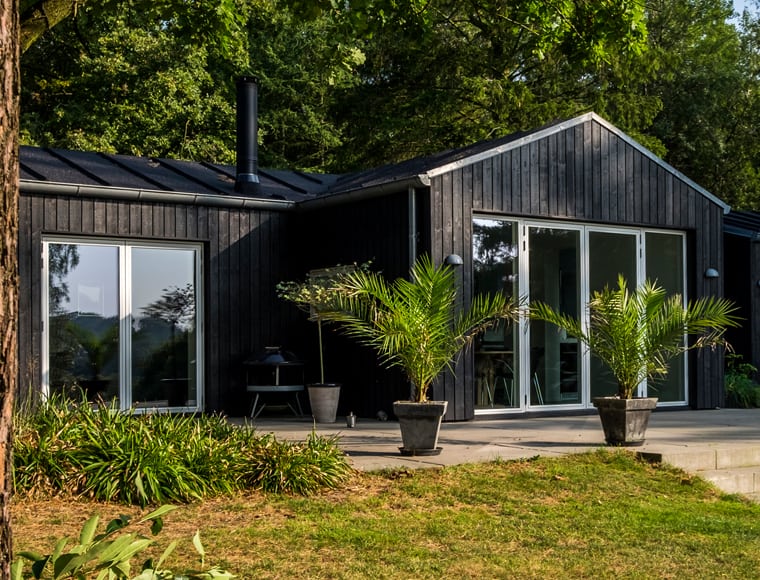 A wooden house surrounded by trees